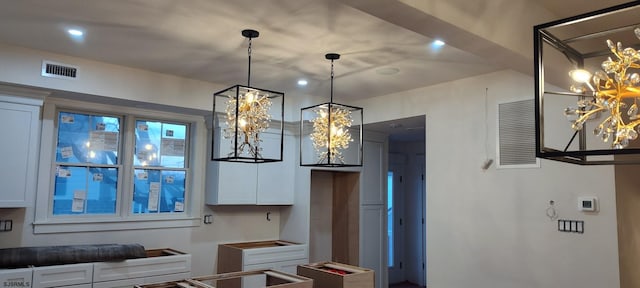 kitchen featuring recessed lighting, visible vents, pendant lighting, and white cabinets