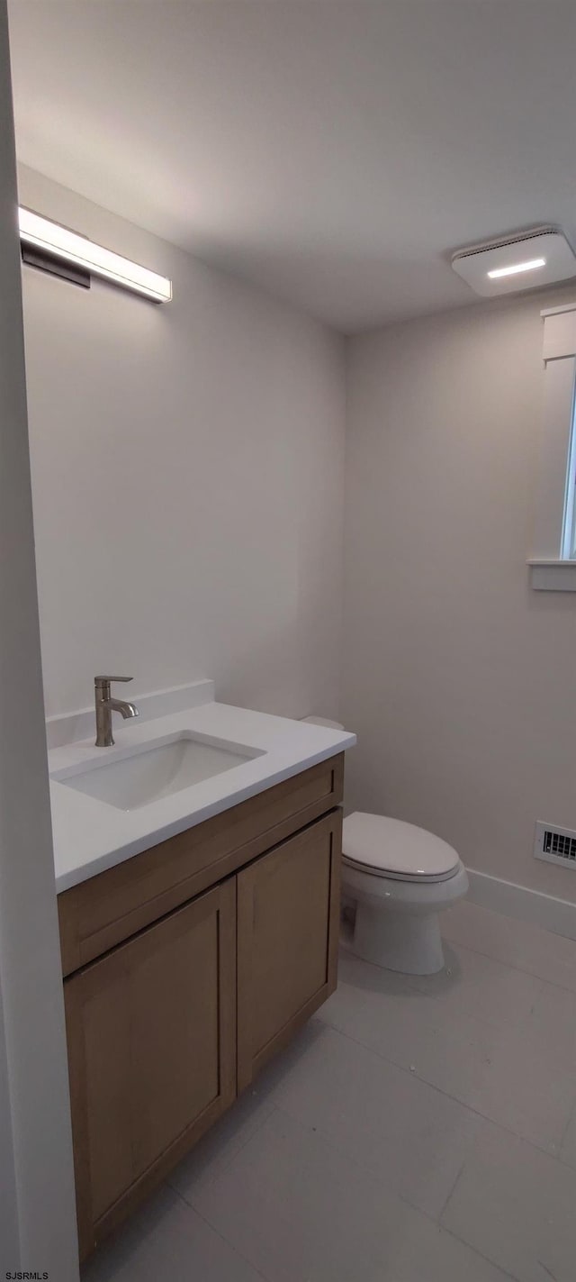 bathroom featuring tile patterned floors, visible vents, toilet, and vanity