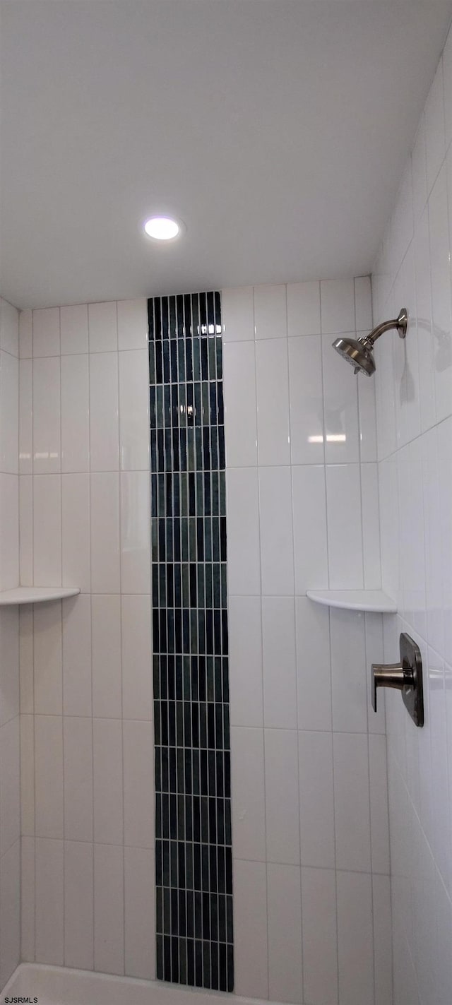 interior details with recessed lighting and tiled shower