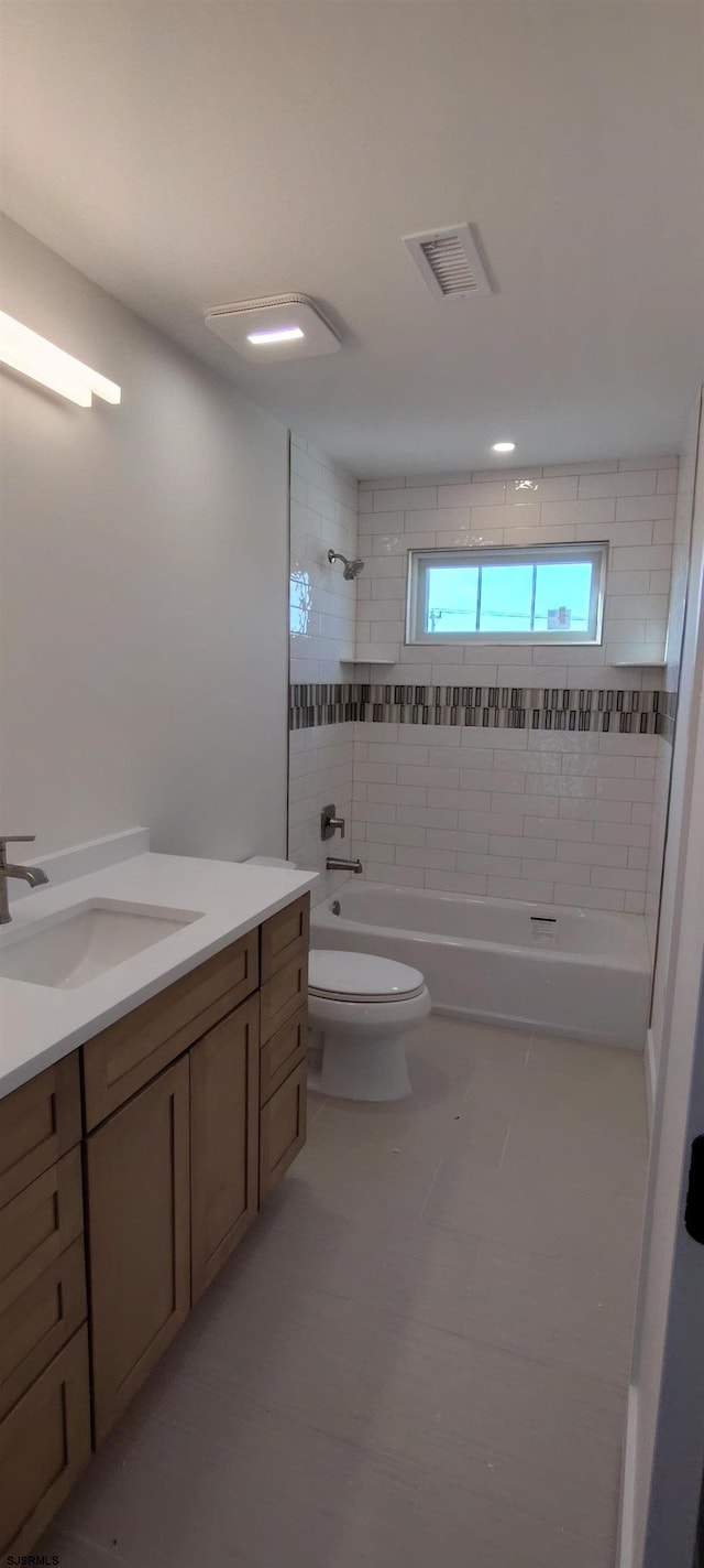 full bathroom featuring visible vents, vanity, toilet, and shower / tub combination