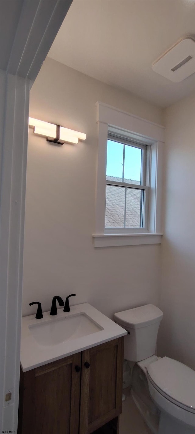 bathroom featuring vanity and toilet