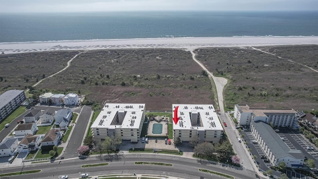 birds eye view of property featuring a water view and a view of the beach