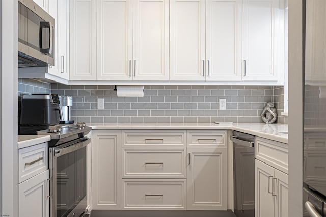 kitchen with backsplash, white cabinetry, and appliances with stainless steel finishes