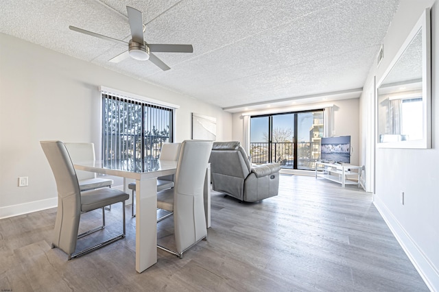 dining space with hardwood / wood-style flooring, a textured ceiling, and ceiling fan