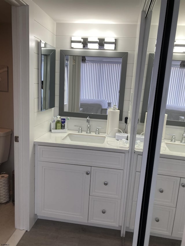 bathroom featuring vanity and toilet