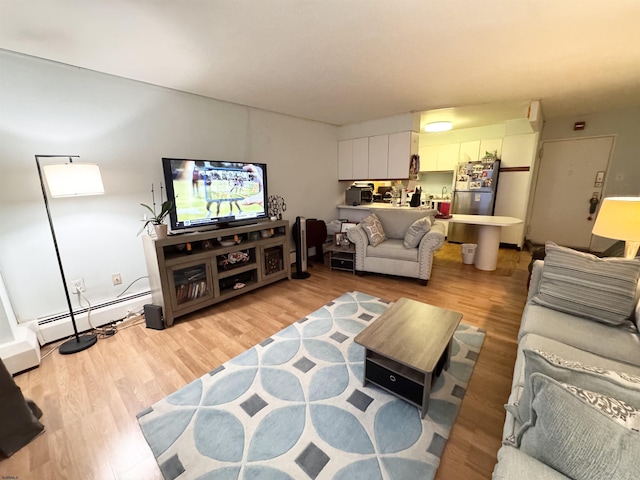 living room featuring a baseboard radiator and light wood-type flooring