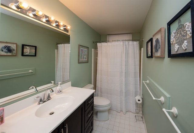 bathroom with tile patterned floors, vanity, toilet, and walk in shower