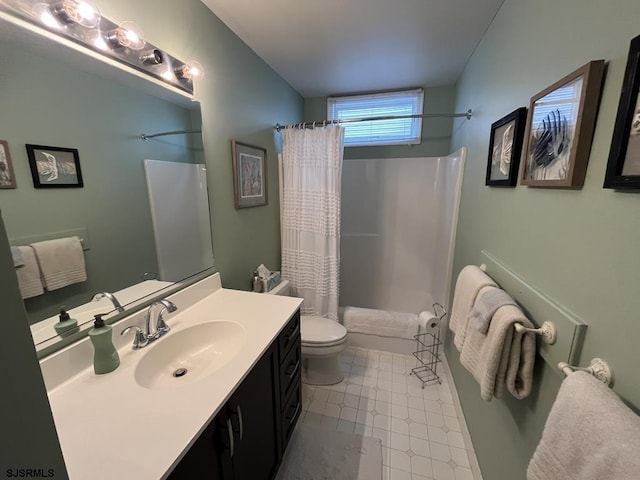 bathroom featuring vanity, toilet, and curtained shower