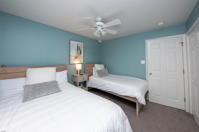 carpeted bedroom featuring a closet and ceiling fan