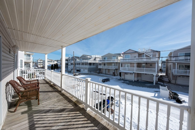 view of snow covered back of property