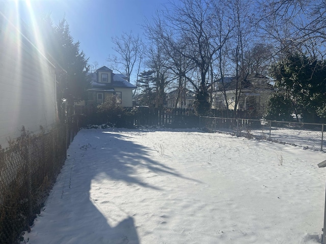 view of yard layered in snow