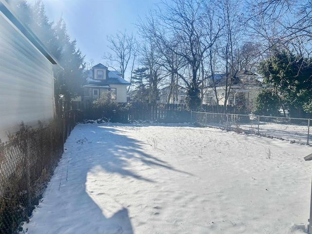 view of yard layered in snow