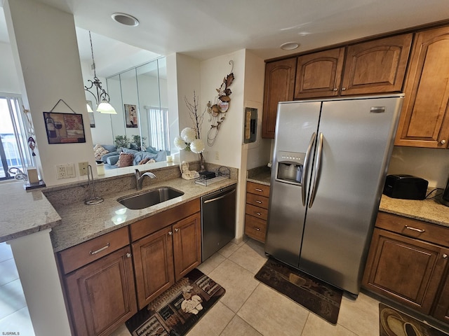 kitchen with sink, light stone counters, stainless steel refrigerator with ice dispenser, dishwashing machine, and light tile patterned floors