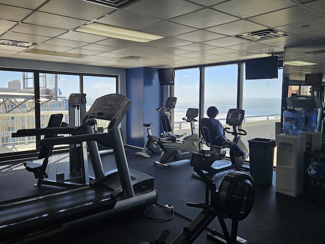 gym with plenty of natural light and a drop ceiling