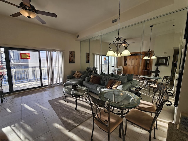 dining room featuring ceiling fan with notable chandelier and light tile patterned flooring