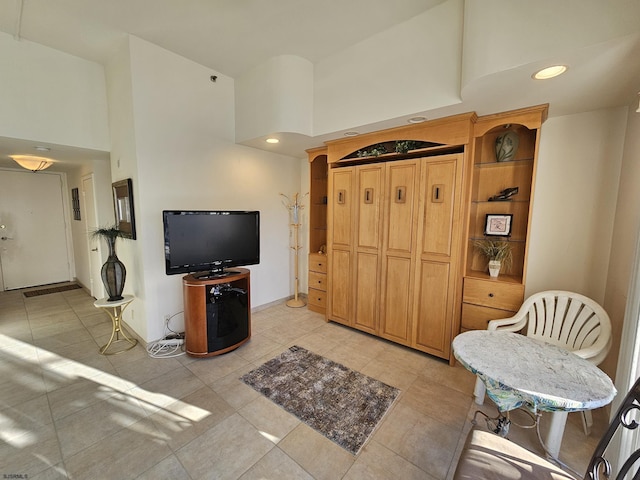 tiled living room featuring a towering ceiling