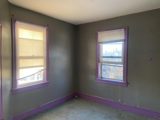 unfurnished room with concrete floors