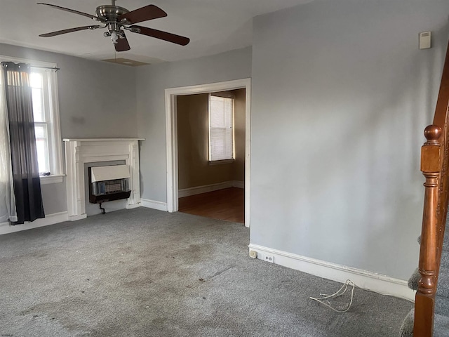 unfurnished living room with carpet flooring and ceiling fan