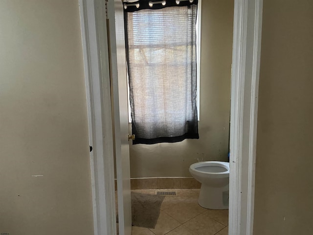 bathroom with tile patterned flooring and toilet