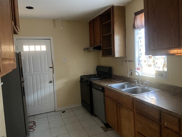 kitchen featuring light tile patterned floors, stainless steel appliances, plenty of natural light, and sink