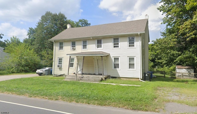 colonial inspired home featuring a front lawn