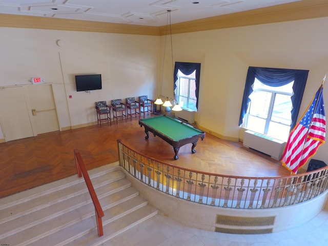 rec room featuring crown molding, parquet flooring, radiator heating unit, and billiards