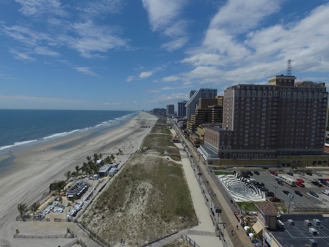 birds eye view of property featuring a water view and a beach view