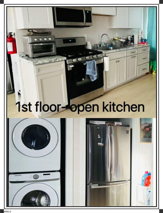 kitchen with white cabinets, stainless steel appliances, and stacked washer and dryer