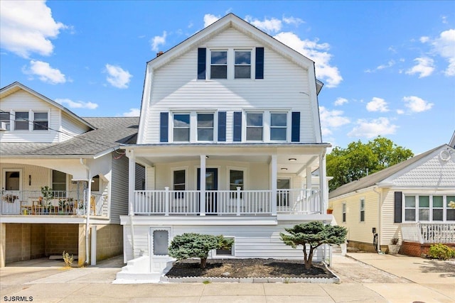 view of front of home with a porch and roof with shingles