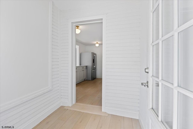 corridor featuring light wood finished floors