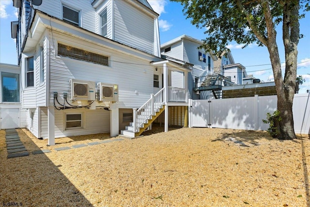 back of property with stairway and fence