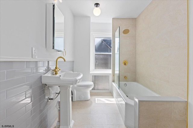 full bathroom with tile walls, bathtub / shower combination, visible vents, toilet, and tile patterned flooring