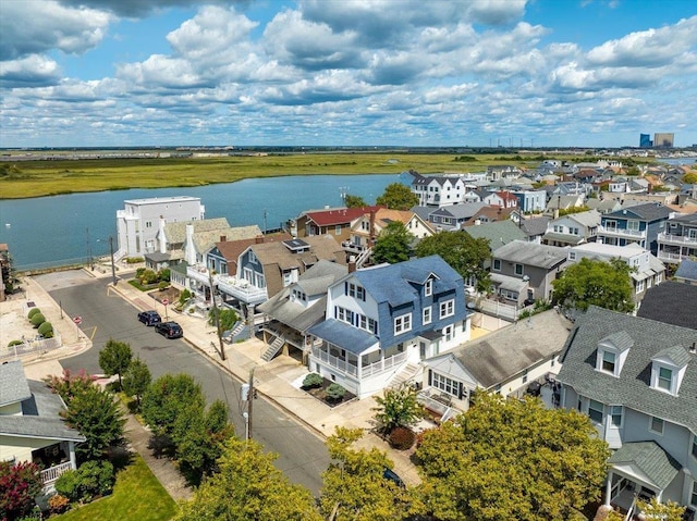 birds eye view of property with a water view and a residential view