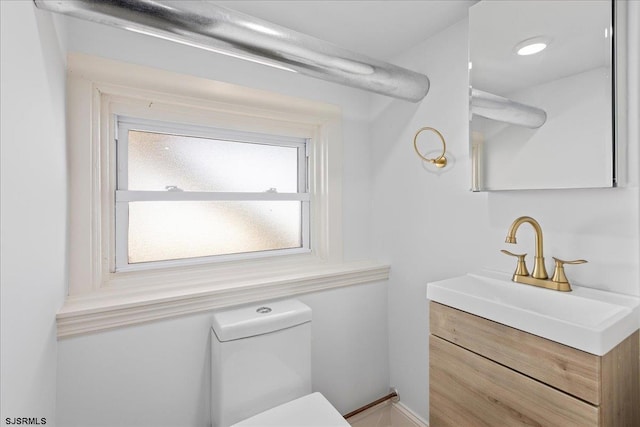 bathroom featuring toilet and vanity