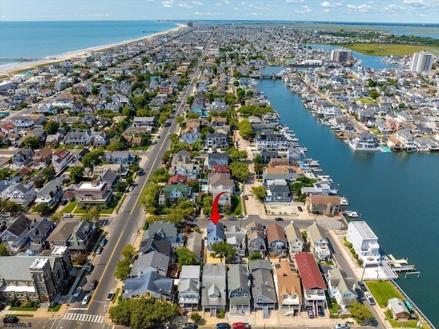 drone / aerial view with a residential view and a water view