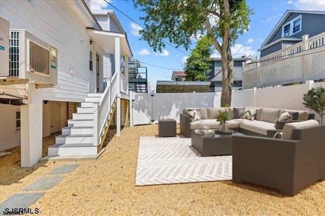 view of patio / terrace with a fenced backyard, stairs, and an outdoor hangout area