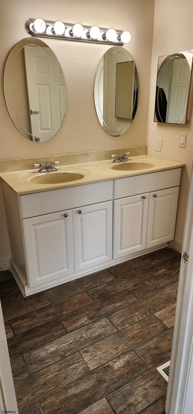 bathroom with vanity and hardwood / wood-style flooring