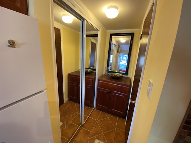 hall with dark tile patterned floors