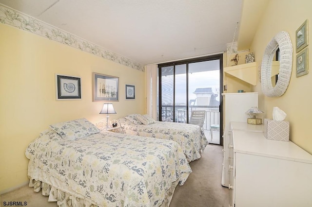 bedroom with carpet floors, access to exterior, and floor to ceiling windows