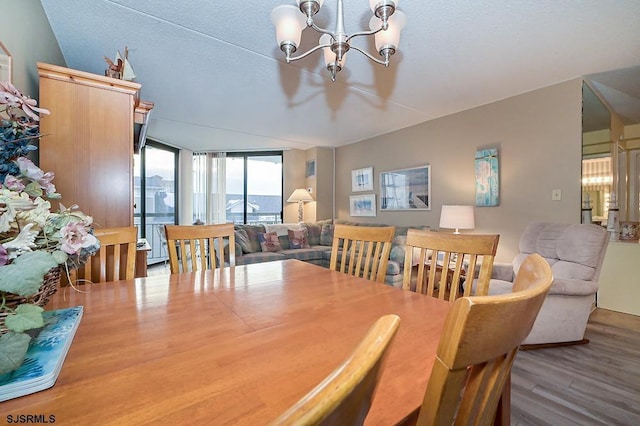 dining room with expansive windows, a notable chandelier, a textured ceiling, and wood finished floors