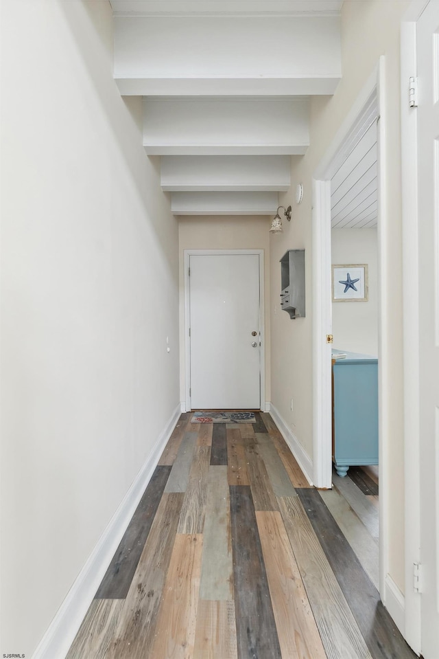 hallway with beam ceiling and dark hardwood / wood-style floors