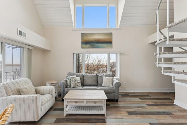 living room featuring dark hardwood / wood-style floors and high vaulted ceiling