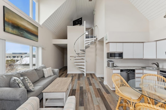 living room with dark hardwood / wood-style flooring, sink, high vaulted ceiling, and wooden ceiling