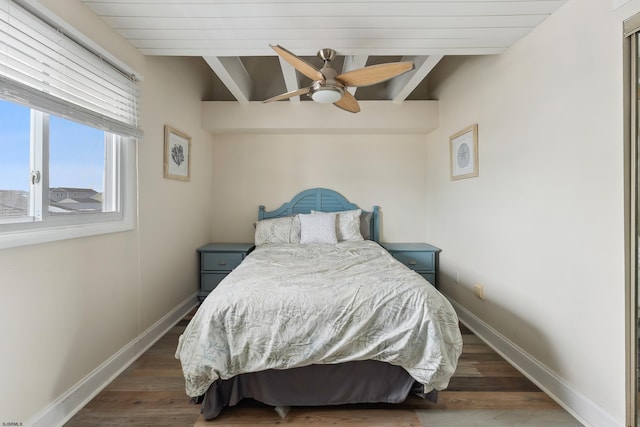 bedroom featuring beam ceiling, ceiling fan, and dark wood-type flooring