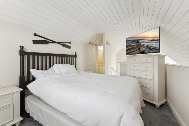 carpeted bedroom featuring ensuite bath, ceiling fan, and wooden ceiling