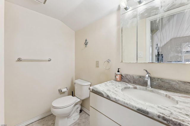 bathroom with tile patterned floors, vanity, toilet, and lofted ceiling