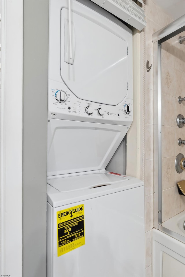 clothes washing area with stacked washer / drying machine