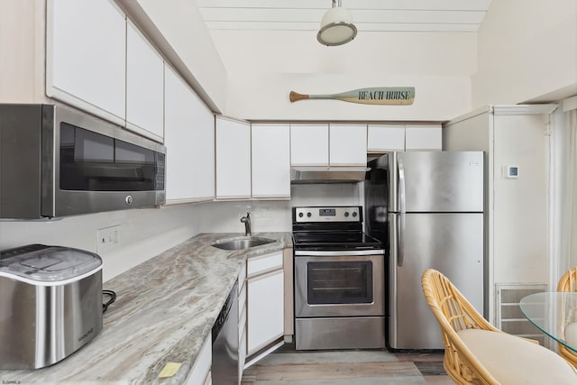 kitchen with light stone countertops, sink, white cabinetry, and stainless steel appliances