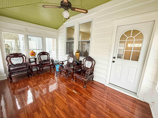 sunroom / solarium with ceiling fan and vaulted ceiling