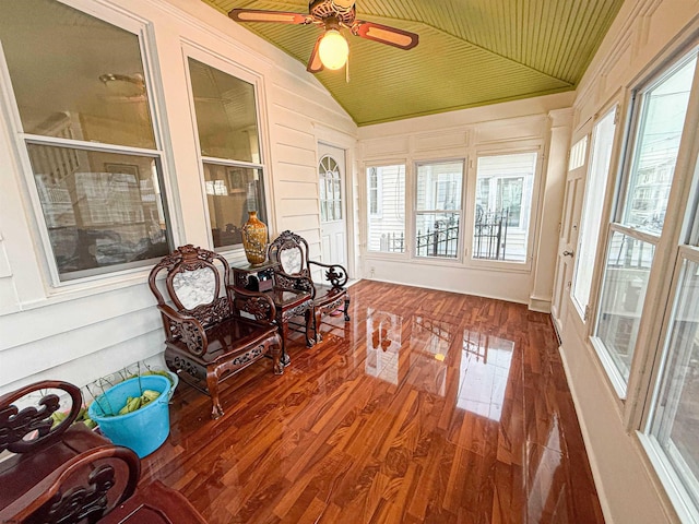 sunroom with vaulted ceiling, ceiling fan, and wooden ceiling